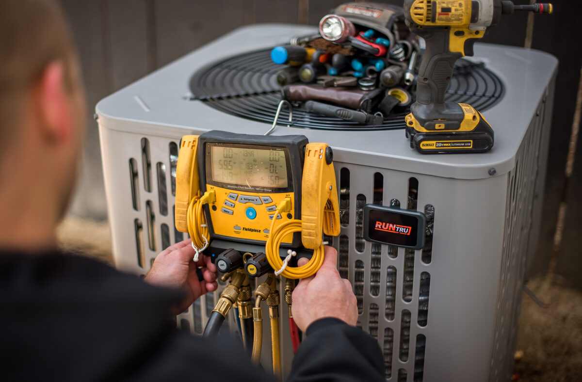 HVAC technician servicing rooftop commercial equipment