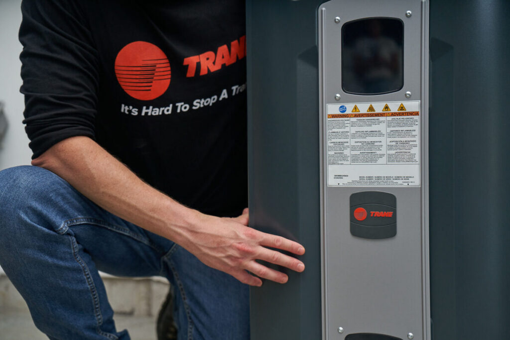 HVAC technician performing maintenance on indoor furnace equipment