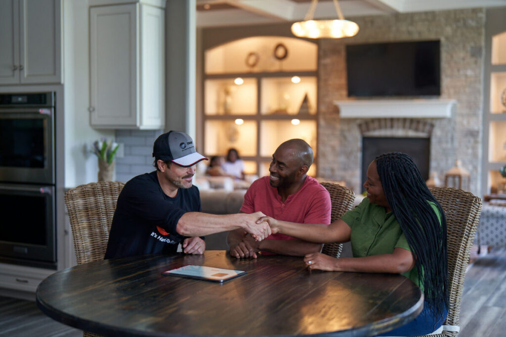 Trane dealer shaking hands with a homeowner indoors
